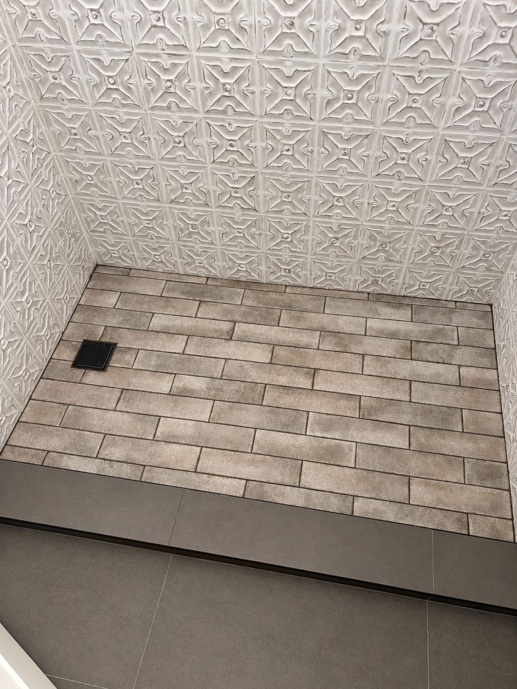 Tin-tile shower with brick-pattern floor and brass drain — one of the tin-tile baths of the mansion remodel, polished brass fixtures to match the master — ProHands LA