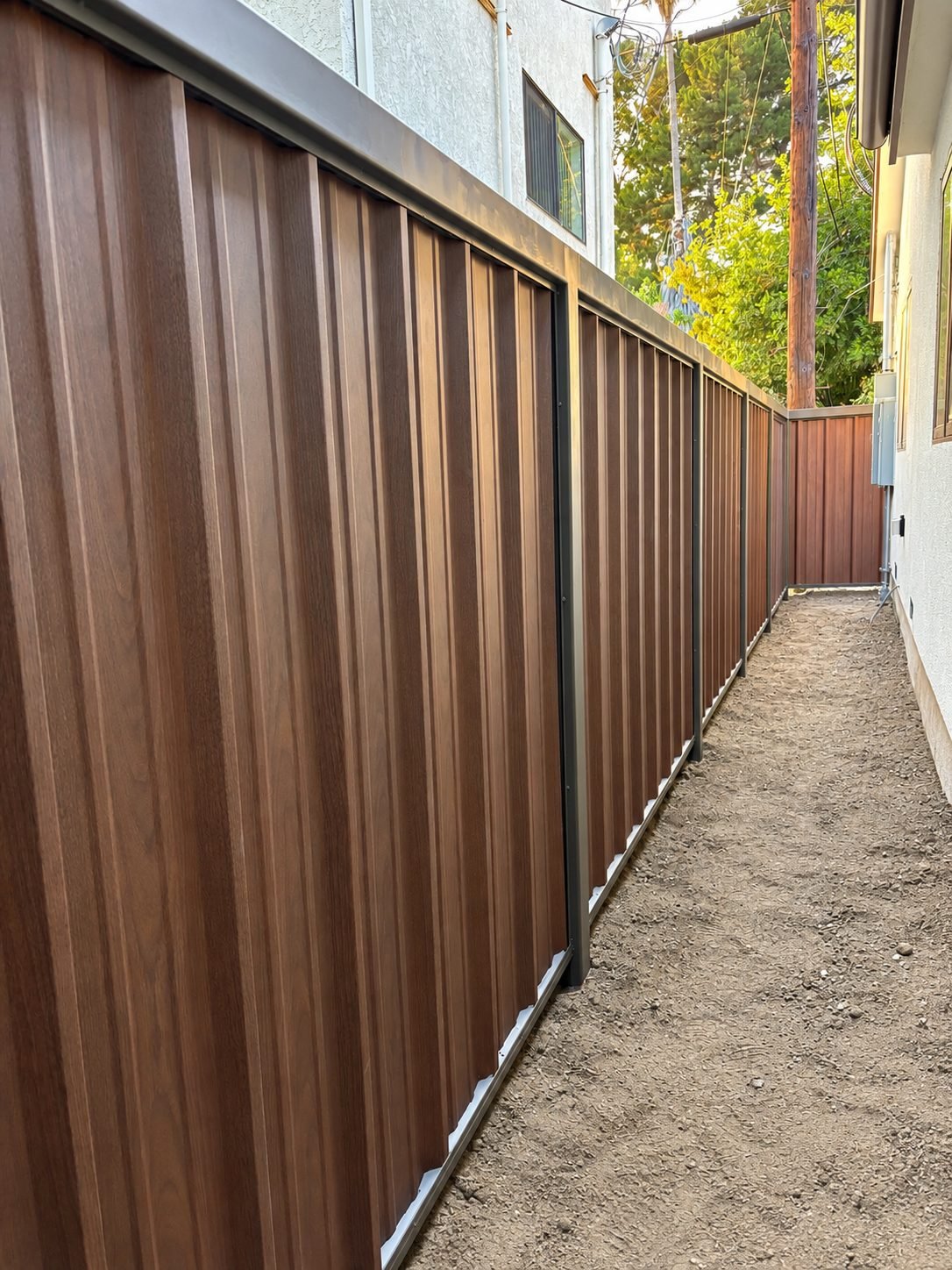 Side alley view of brown wood-tone steel panels, elegant finish