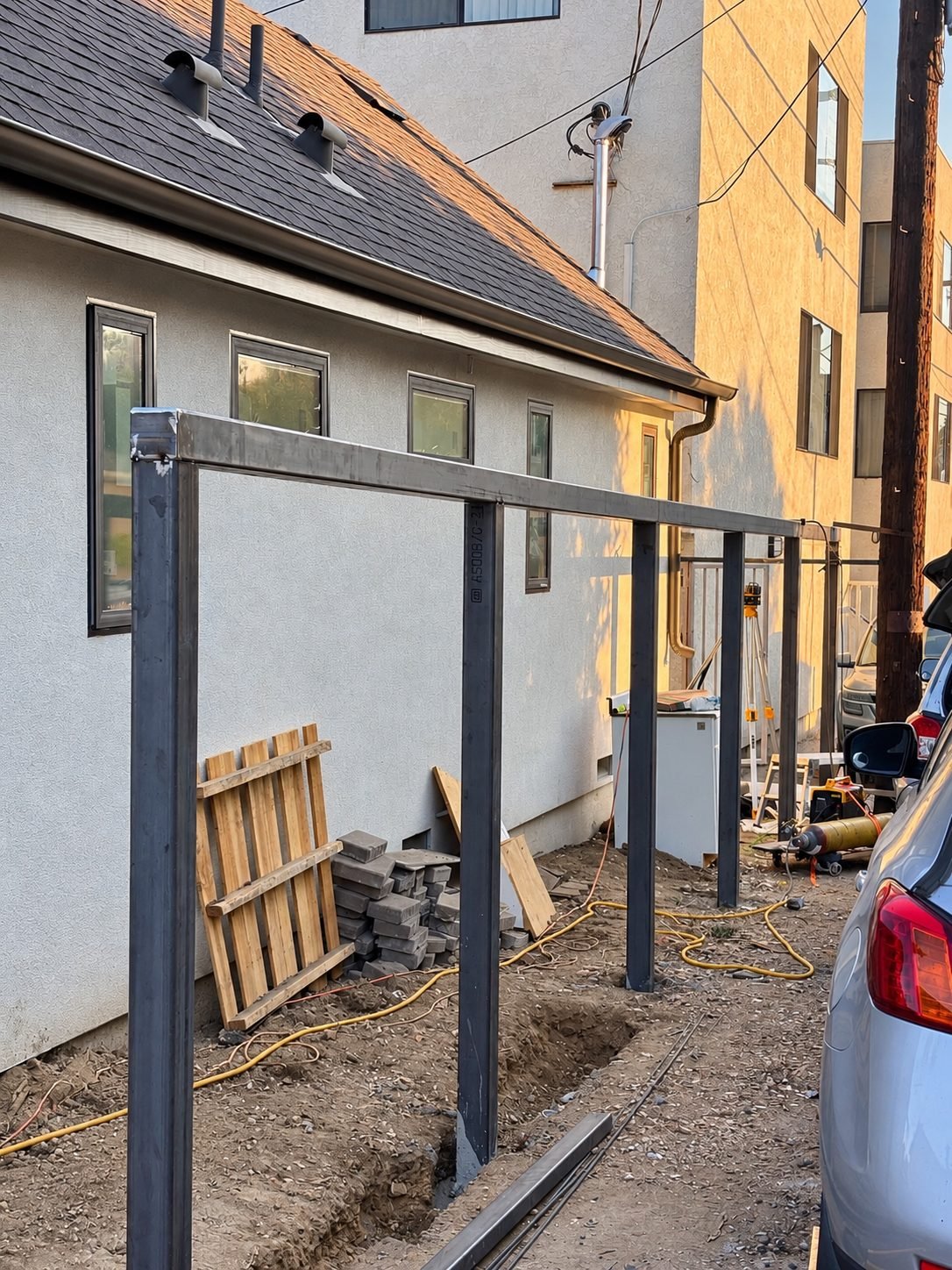 Construction phase — steel frame posts and top beam installed, bare steel before paint