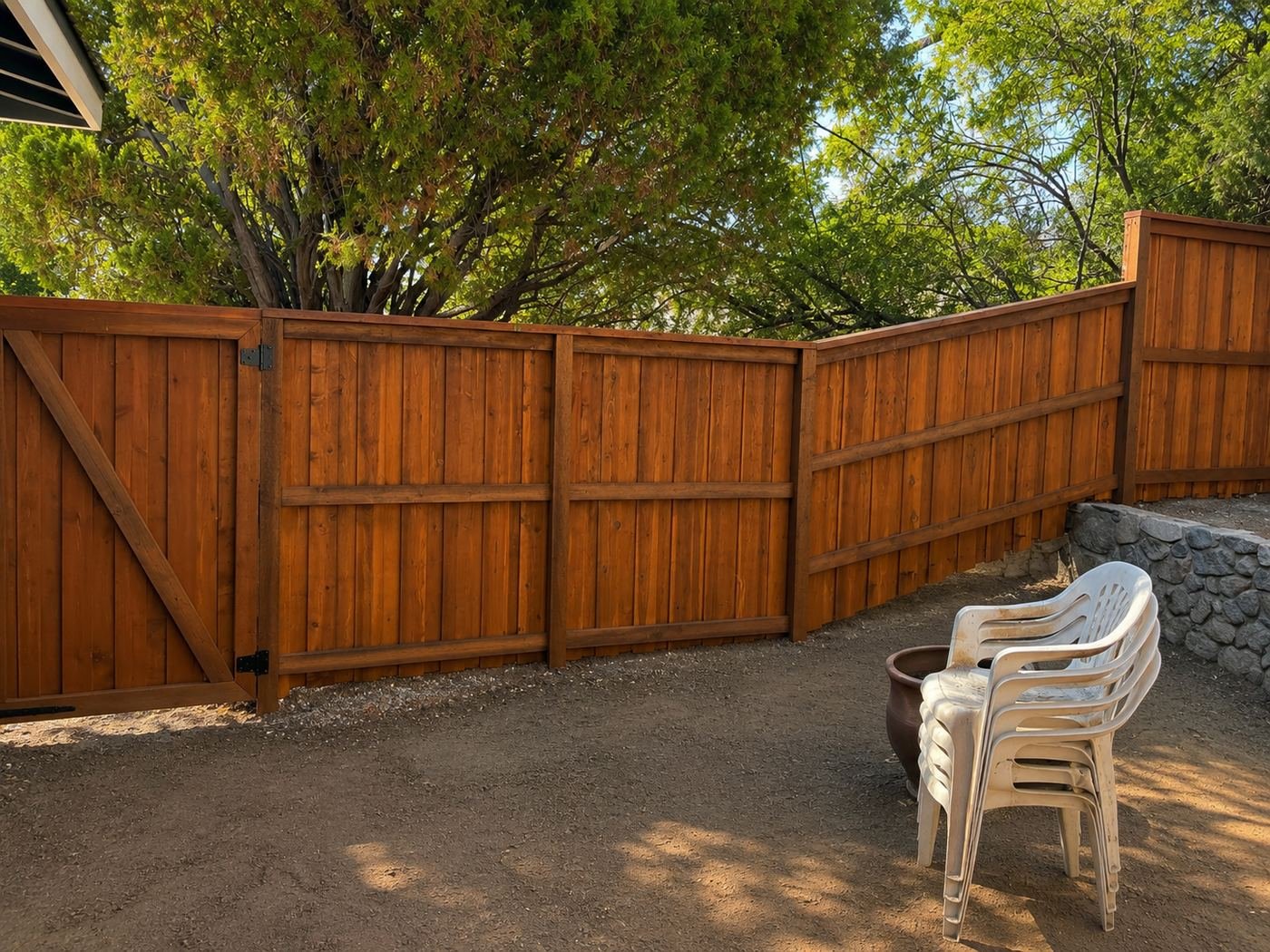 New cedar privacy fence with Z-brace matching gate and warm honey-stain finish along a backyard corner at a Los Angeles home — ProHands